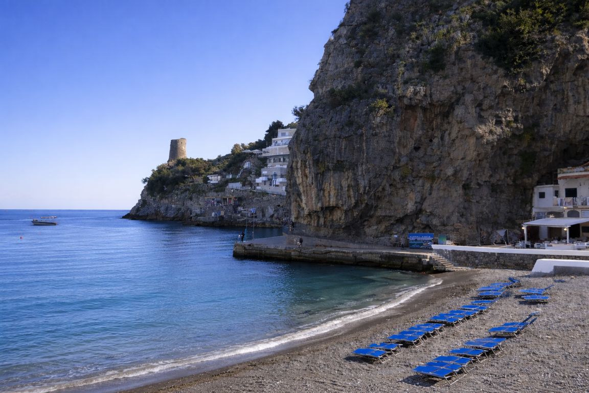 Marina di Praia beach in Praiano with cliffs and calm sea during guided visit with Italy Amalfi Coast Tours